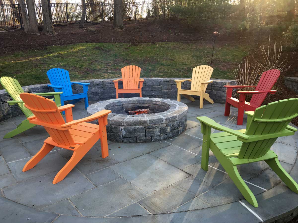 fire pit with colorful lawn chairs