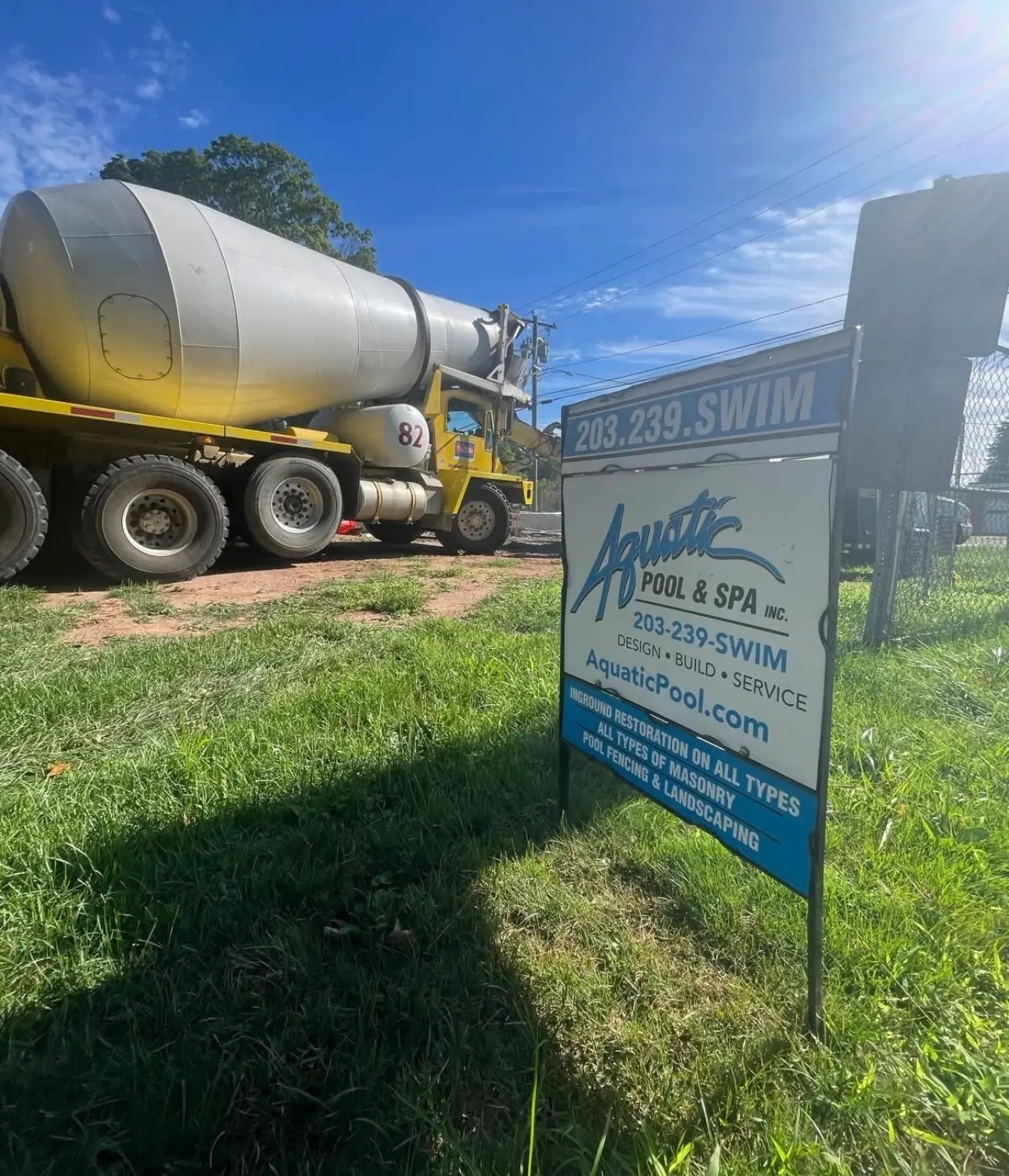 Concrete truck behind yard sign